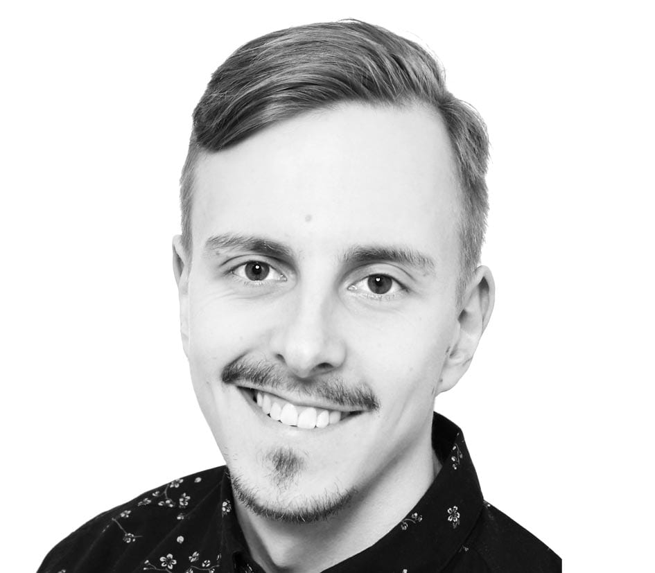 short haired guy smiling on the camera