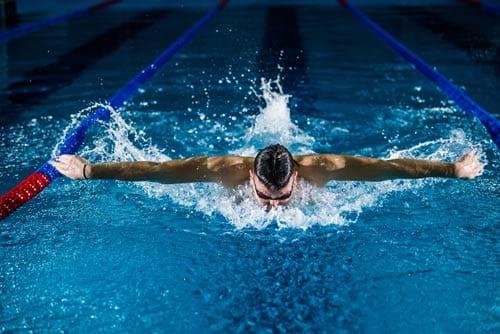man is swimming in a pool