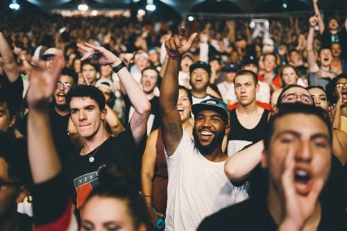 a crowd of people is cheering and being happy